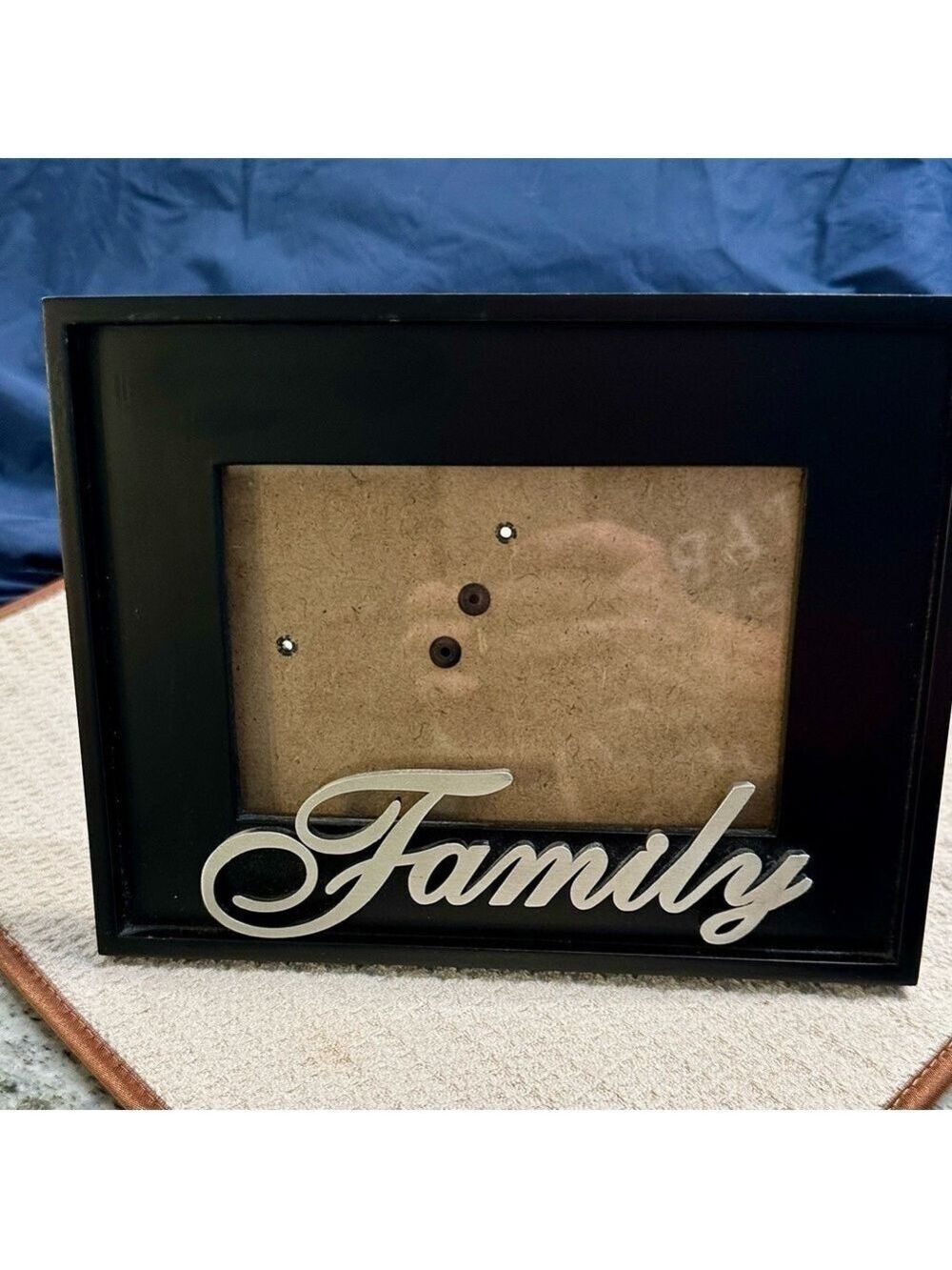 Family Photo Frame. Black wooden frame. Family in script writing made of pewter.